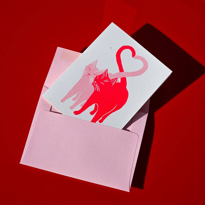Pink and red Love Cats Risograph greeting card by Bromstad Printing Co. with playful cat illustrations on textured paper.