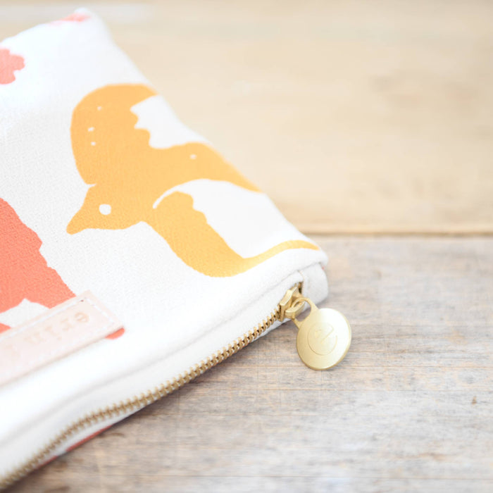 Tangerine and coral birds toiletry bag by Erin Flett with a vibrant floral pattern, featuring a zipper closure and compact design.