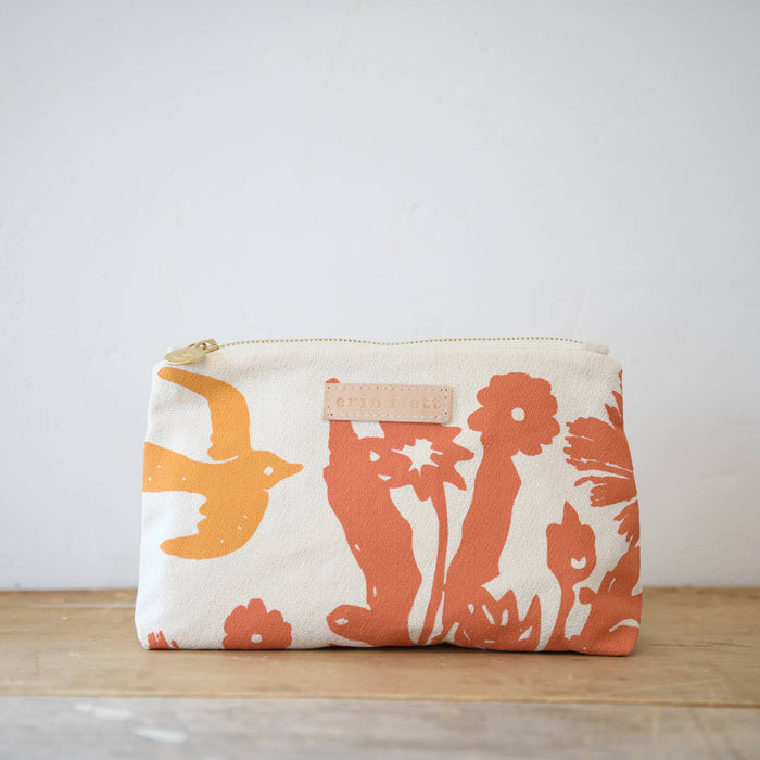 Tangerine and coral birds toiletry bag by Erin Flett with colorful bird illustrations on a fabric pouch.