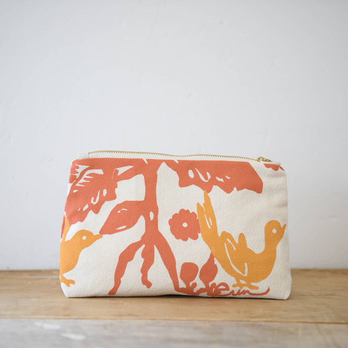 Tangerine and coral birds toiletry bag by Erin Flett, featuring a vibrant floral and bird pattern on a fabric pouch.